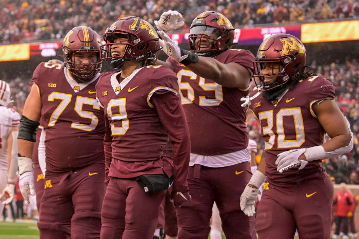 Nov 25, 2023; Minneapolis, Minnesota, USA; Minnesota Golden Gophers wide receiver Daniel Jackson (9) celebrates his 7-yard touchdown reception against the Wisconsin Badgers with offensive lineman Tyler Cooper (75), offensive lineman Aireontae Ersery (69), and running back Jordan Nubin (30) during the second quarter at Huntington Bank Stadium.